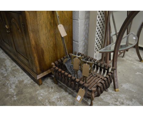 Cast iron fire grate, pair of brass fire dogs with two fireside tools.