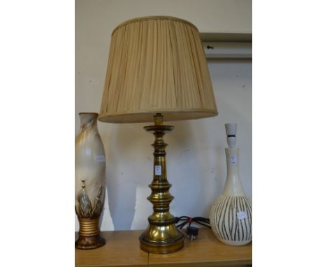 A large brass table lamp and shade.