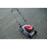 A Honda petrol rotary lawn mower.