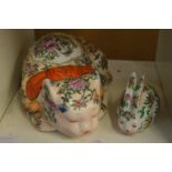 A Chinese style famille rose pottery cat and similar rabbit.
