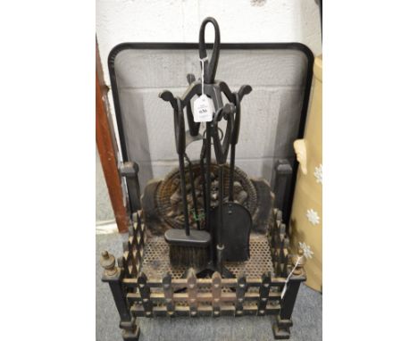 A cast iron fire grate, wrought iron companion set and a spark guard.