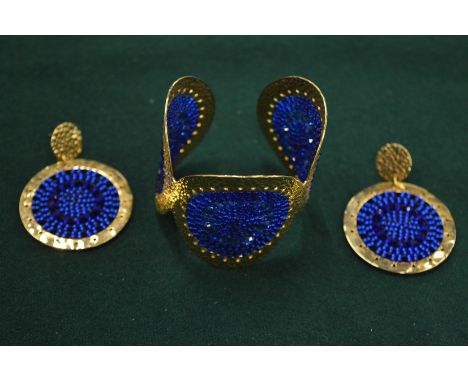 Decorative bangle with matching pair of earrings.