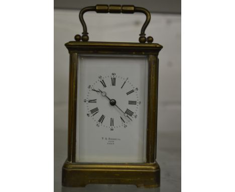 A brass carriage clock.