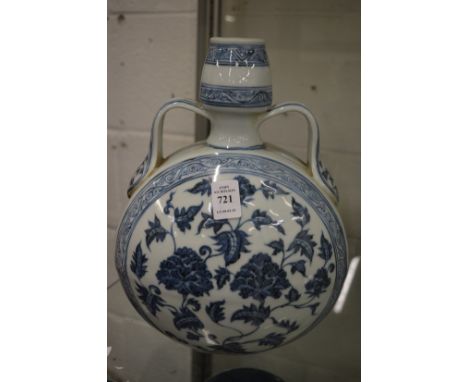 A Chinese blue and white moon flask painted with flowers.