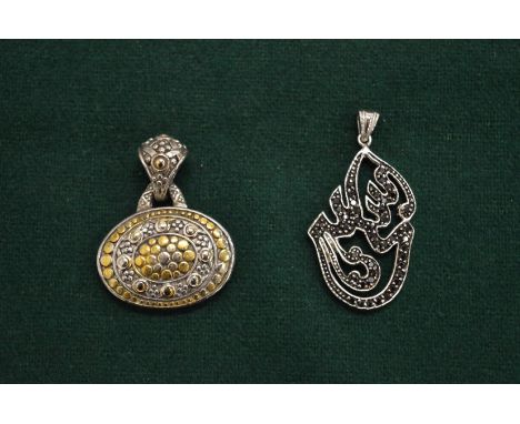 Two decorative&nbsp;silver pendants.
