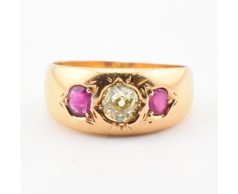 An 18ct gold ruby and yellow diamond gypsy ring. The ring set with a central old cut yellow diamond flanked by two rubies to 