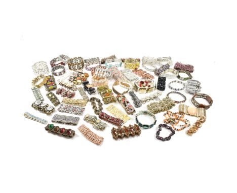 An assorted collection of costume jewellery bracelets. The lot to include gold and silver tone metal, white stones, various c