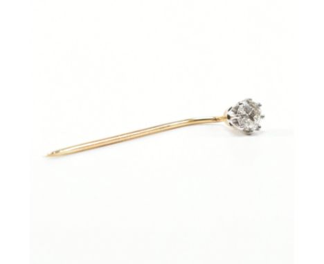 An antique diamond and yellow metal stick pin. The pin having a round cut decorative eight prong set diamond to a yellow meta