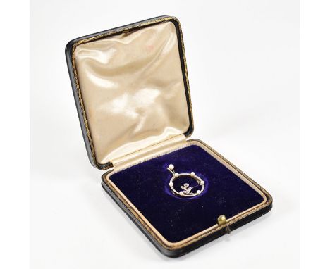 A 1920s belle époque 15ct gold and platinum pearl and diamond pendant brooch pin. The pendant in the form of a roundel set wi