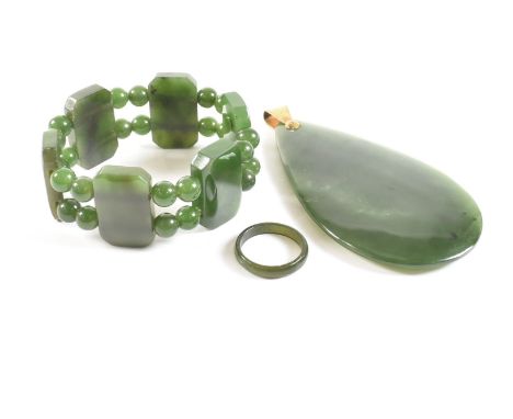 A group of vintage nephrite jade jewellery. The lot to include a statement pear cut mottled green heard stone necklace pendan