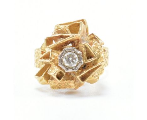 1970s brutalist gold and diamond cluster ring. The ring set with a round brilliant cut diamond to geometric brutalist dome ha