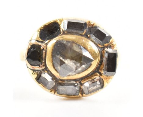 An antique gold and diamond cluster ring. The ring set with rose and step cut diamonds to a bezel setting. Plain band. Weight