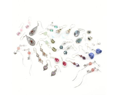 An assorted collection of 925 silver earrings. The lot to include garnet, ruby, amethyst, jade, opaline glass, skulls, simula