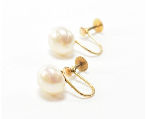 A pair of vintage 9ct gold screw back earrings. Each earring having a simulated button pearl to screw back verso. Marked 9ct.