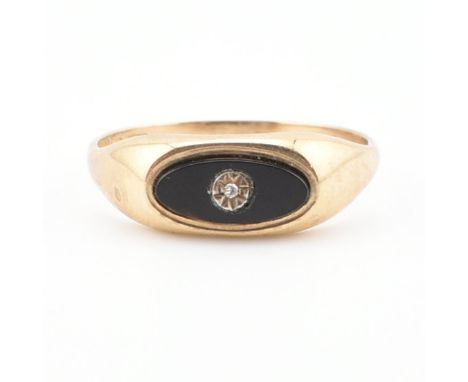 A hallmarked Onyx and diamond signet ring. The ring set with an illusion cut diamond to an oval onyx mount to plain band. Wei