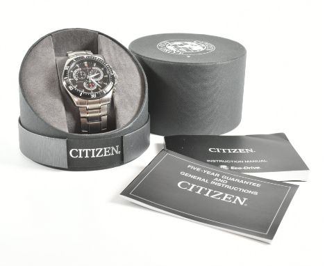 A Citizen Eco-Drive wrist watch. The watch having black dial with chronograph, presented in original case with paperwork. Fac