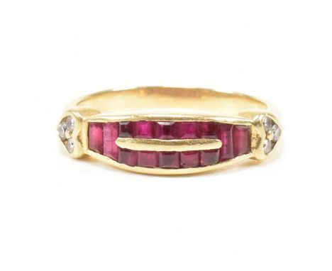 A vintage yellow metal, ruby and diamond cluster ring. The ring having a cluster of trapeze and square cut rubies to the loze