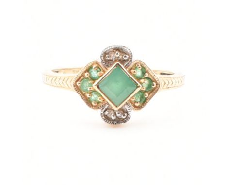 A gold emerald and diamond ring. The ring set with a central square step cut emerald with round cut emeralds and diamonds. Ma