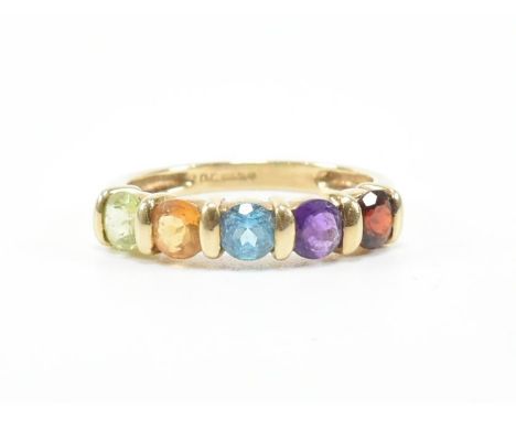 A hallmarked 9ct gold and multi gem set five stone ring. The ring set with garnet, amethyst, topaz, citrine, peridot to plain