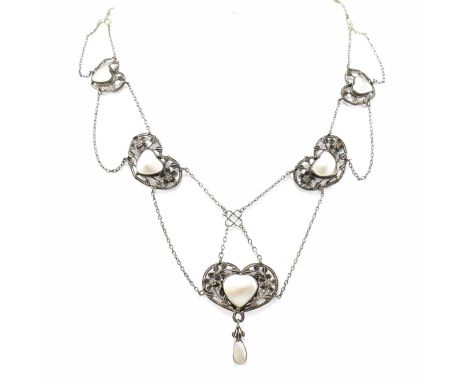An Arts and Crafts silver and mother of pearl necklace. The necklace strung with five graduating heart shape panels set with 