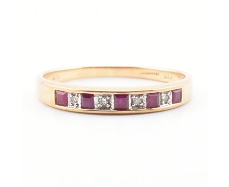 A hallmarked 9ct gold and ruby half eternity ring. The ring set with square step cut rubies and illusion set diamonds to tape