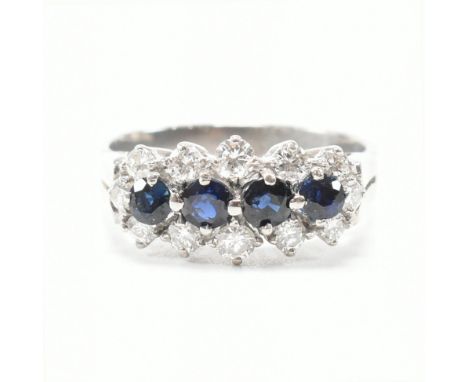 A vintage platinum and 18ct white gold, sapphire and diamond dress ring. The cluster ring having our round cut sapphires to t