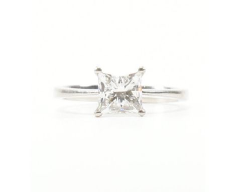 A vintage 900 white platinum and GIA certified diamond solitaire ring. The single stone engagement style ring having a square