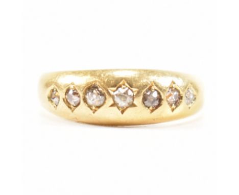 An 18ct gold seven stone diamond gypsy ring. The ring having hallmarks for London, date letter O (19th century) Weight 3.8g. 