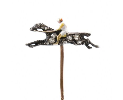 A gold enamel and diamond stick pin. The stick pin mounted with horse and jockey. The horse set with rose cut diamonds. The j