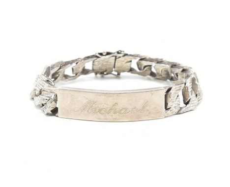 A 1970s vintage hallmarked 925 silver ID bracelet. The bracelet having textured bark curb links to ID panel engraved Michael.