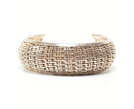 A vintage 925 silver cuff bangle bracelet. The bangle of pressed fancy link chain atop a silver ground contoured form. Marked