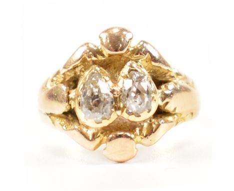 A Victorian 19th century diamond ring. The ring set with 2 pear cut diamonds to scrolled mount with plain tapering shank. Tot