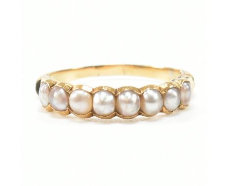 A vintage AF yellow metal and pearl ring. The ring having eight half bezel set pearls to concave shoulders and tapered shank.