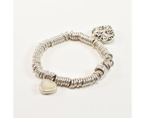 A 925 silver Charms bracelet. The bracelet comprised of silver hoops with an open work scrolling heart charm and a black enam