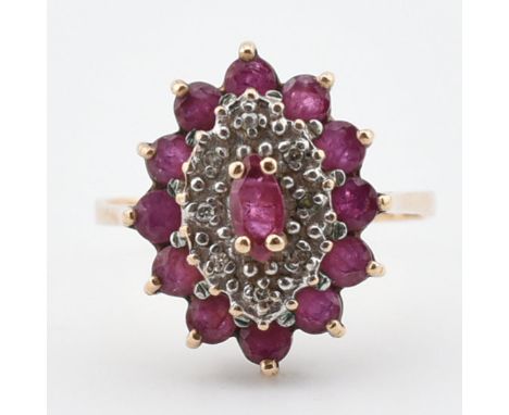 A gold ruby and diamond cluster ring. The ring set with a marquise cut ruby surrounded by illusion set diamonds and round cut