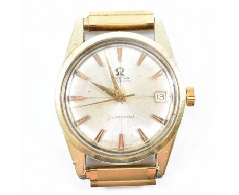 A vintage Omega Seamaster gold plated wristwatch. The watch having a circular champagne colour dial with faceted chevron indi