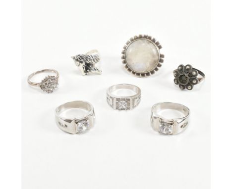 An assorted collection of 925 silver and white metal rings. The lot to include a statement round cut moonstone cabochon bezel