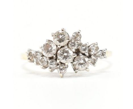 A vintage 18ct yellow gold and diamond cluster ring. The ring having a cluster of 15 round cut diamonds of various sizes to p