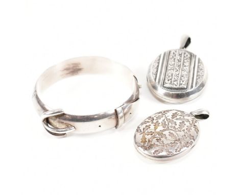 A Victorian buckle bangle and two lockets. The bangle in the form of a belt buckle, unmarked. A locket having oak leaf emboss