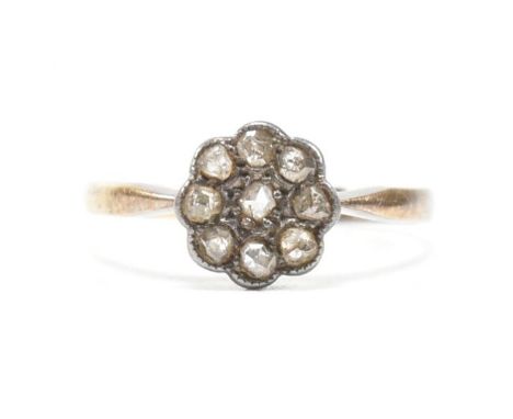 An antique 18ct gold and diamond cluster ring. The ring having a central round cut diamond surrounded by a halo of eight furt