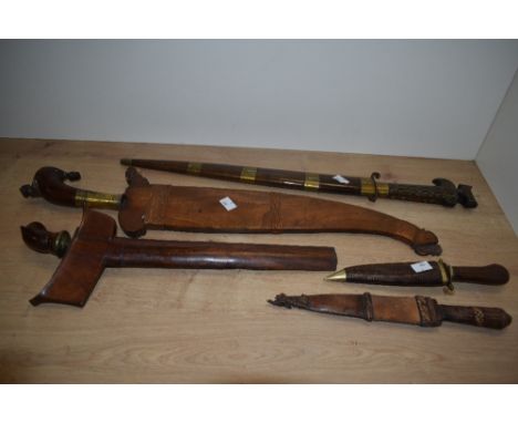 A 19th/20th Century Eastern Moro Barong sword, within a copper wire bound scabbard and having a brass mounted and wooden grip