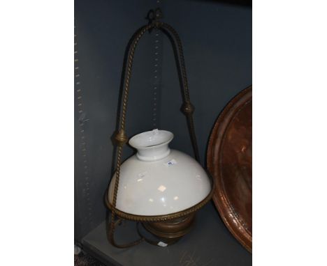 A late 19th Century copper hanging lamp, having a milk glass shade and suspended within a rope twist frame, measuring 74cm hi