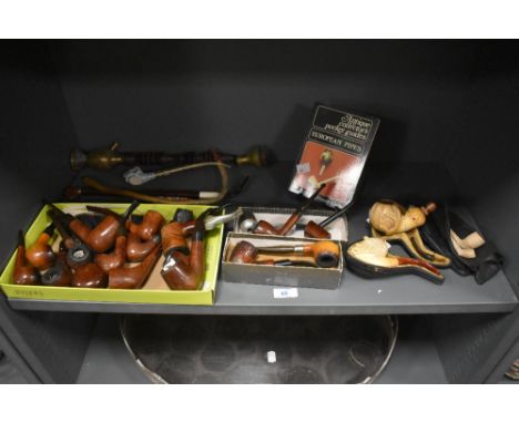 A Meerschaum Bacchus pipe, measuring 15cm long and with case, together with a selection of other clay, wooden, and porcelain 