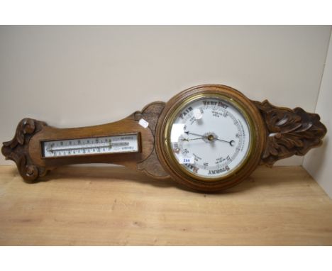 A late 19th Century oak cased aneroid barometer, measuring 35cm long
