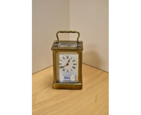 An early 20th Century French carriage clock, having brass four glass sided case and enamelled Roman dial, measuring 15cm high