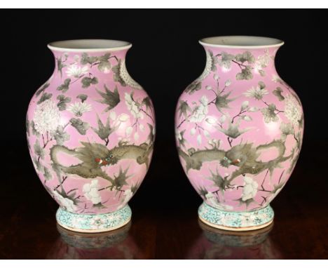A Pair of 19th Century Chinese Ovoid Vases decorated with pairs of scrolling dragons; one black, on rusty orange with gilt sc