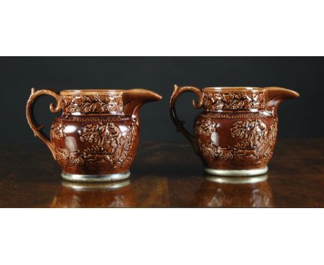 A Pair of Treacle Glaze Jugs moulded in relief with hunting scenes and mounted on silver plated bases. 