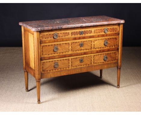 A Late 18th/Early 19th Century French Brêche Marble-topped Commode with three long tulipwood veneered drawers inlaid with dec