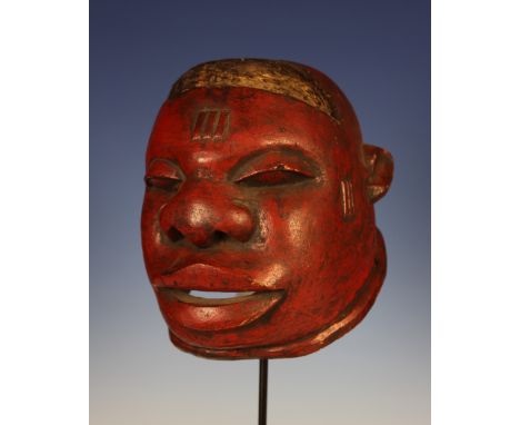 A Fine African Makonde Red Painted Helmet from the Tanzania Region with inset hair and scarification marks.