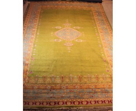 A Near Pair of Large Turkish Wool Carpets Circa 1920 woven with an unusual palette of coral, orange, ivory & blue motifs on c